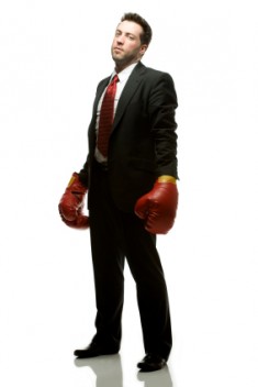businessmanwithgloves1 235x352 custom Determinant Paradigms: Scarcity vs. Abundance